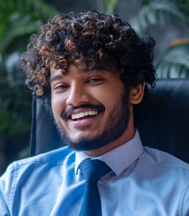 Man sitting at office table looking at camera